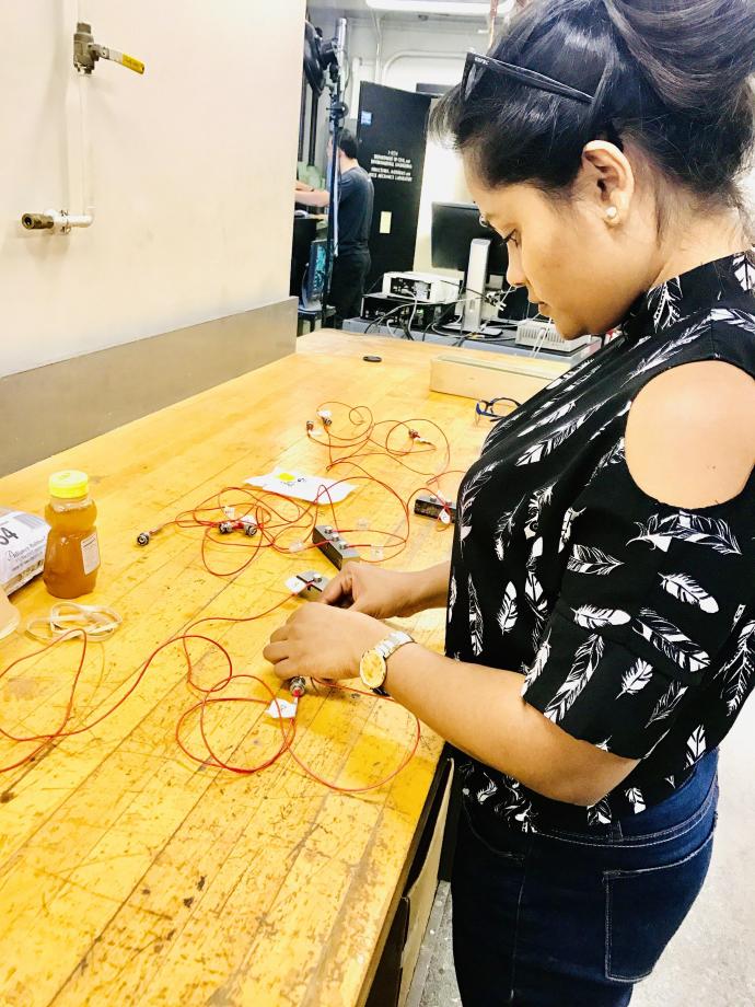 Doctoral student Gayani Gunarathna, who gleaned valuable insights from the Ph.D. Professional Development Series, prepares acoustic emission sensors for a hydraulic fracturing test. 