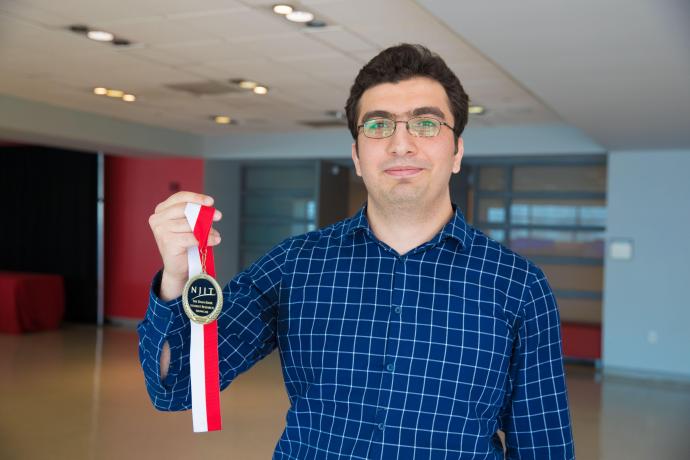 Najmaddin Akhundov presents his first-prize graduate student researcher medal at the 2018 Knox Student Research Showcase.