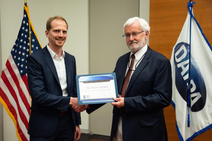 Simon Garnier receives YFA honors from Michael Fiddy, program manager for DARPA's Defense Sciences Office.