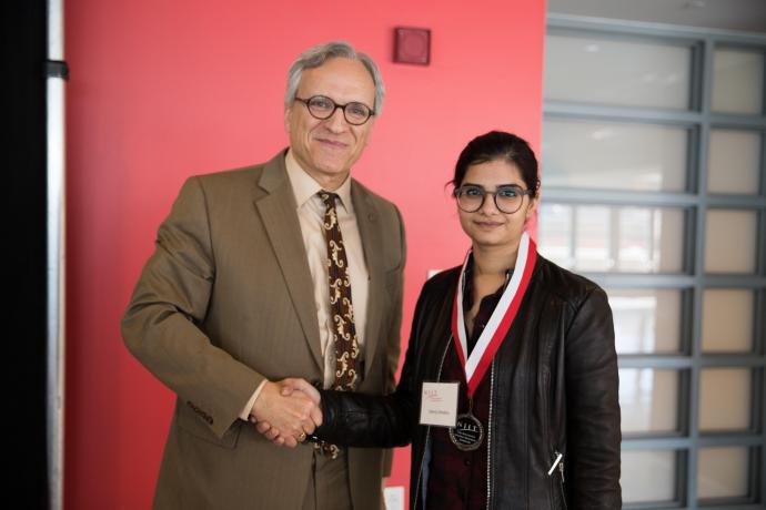 NJIT Provost and Senior Executive Vice President Fadi P. Deek awards graduate student Sherry Chhabra.