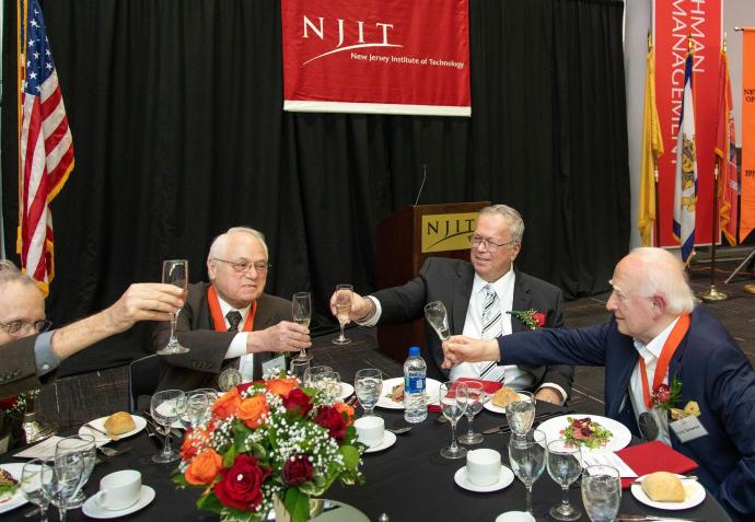 NCE 100 Honorees Pierre Ramond, Heinz Bloch and Yuriy Tarnawsky share a toast with NCE Dean Moshe Kam (second from right).
