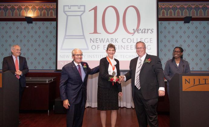 NCE 100 Honoree Ellen Pawlikowski with NJIT President Joel Bloom (near left) and NCE Dean Moshe Kam (near right). The presenters, NJIT Trustee Robert Cohen (left) and NCE Associate Dean for Research Janice Daniels (right), look on. 