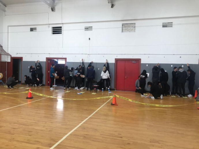In Newark’s East Side High School gymnasium, Carman’s class learn to take bullet trajectory measurements the way forensic scientists do to determine the height of a shooter.