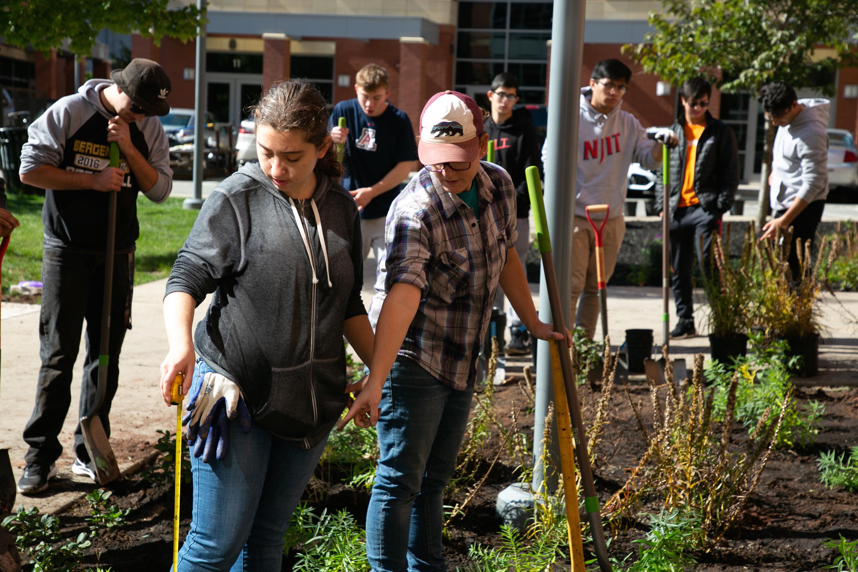 Deanna Mostafa, Honors first-year student (front left), and Caroline DeVan, biological sciences lecturer, participate in the college's biodiversity project. 