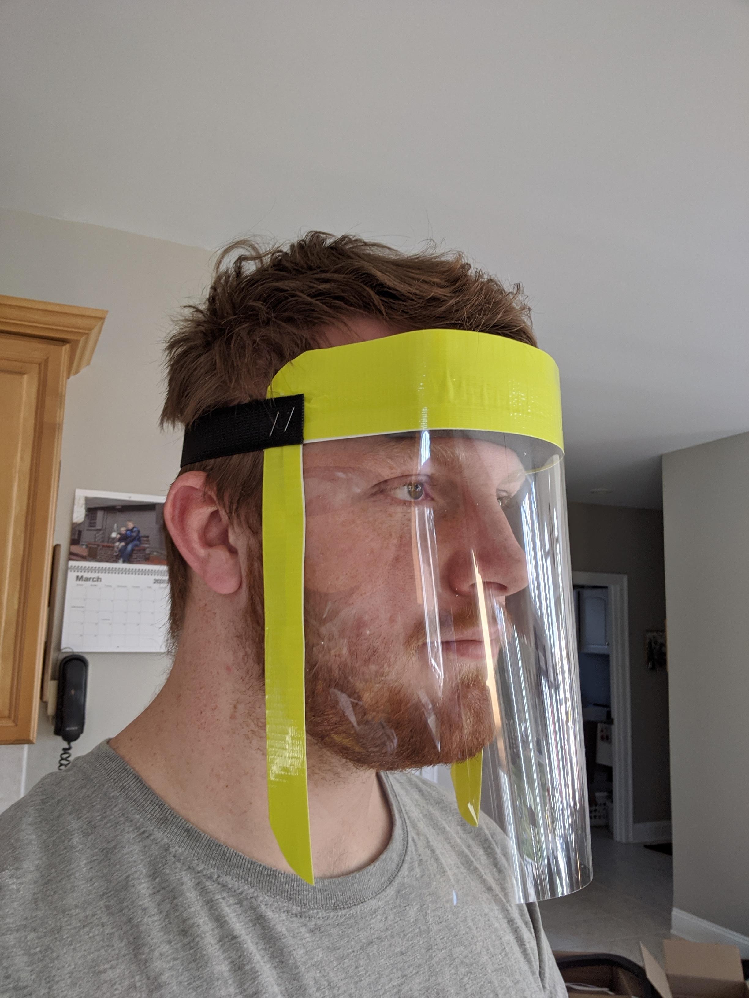(Above) Honors student and mechanical engineering major Greg Tanis wears one of the hundreds of face shields he produced (below) for local hospitals and emergency responders.
