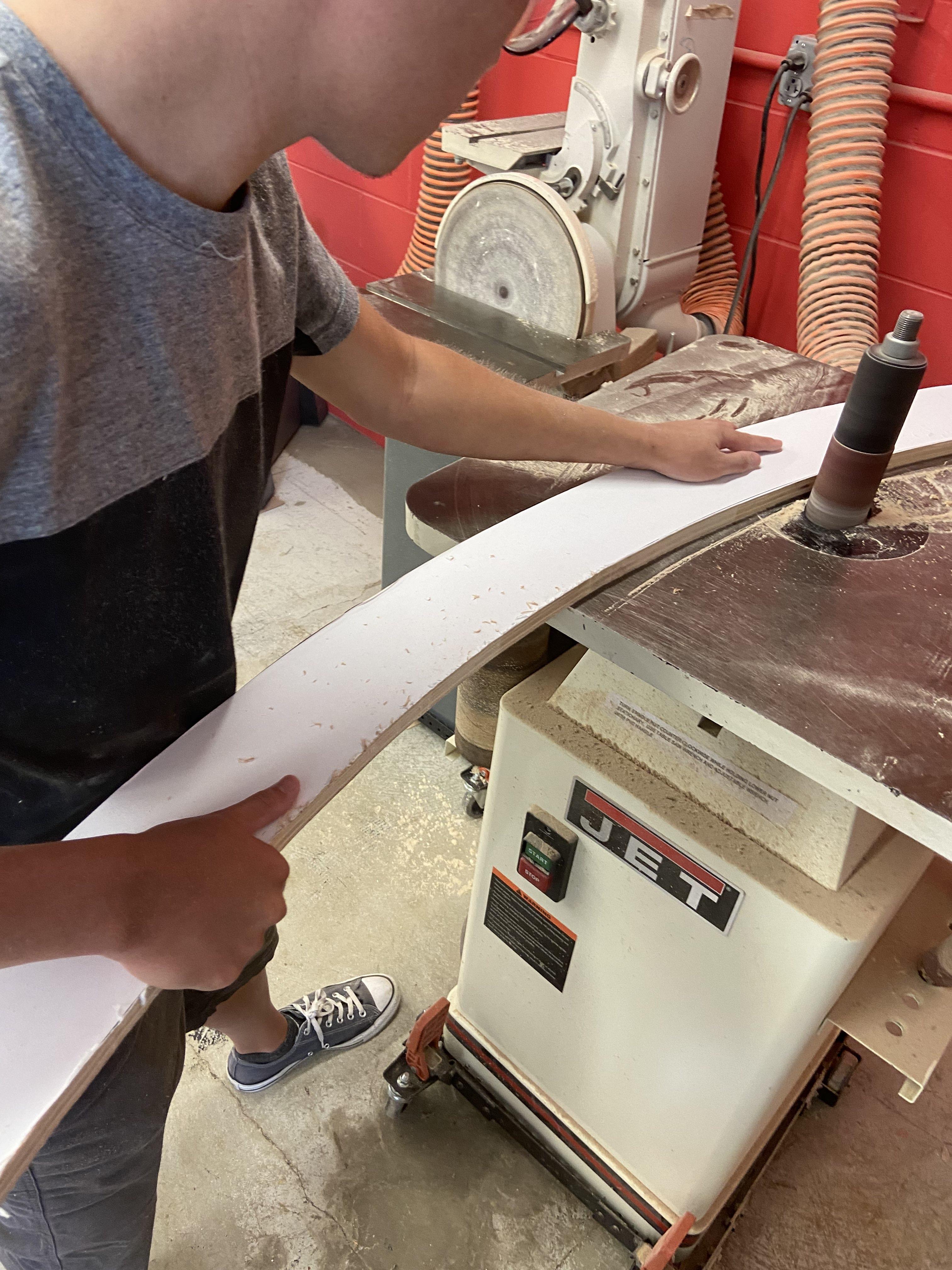Kyle Schmitt sanding down the base of his team's 