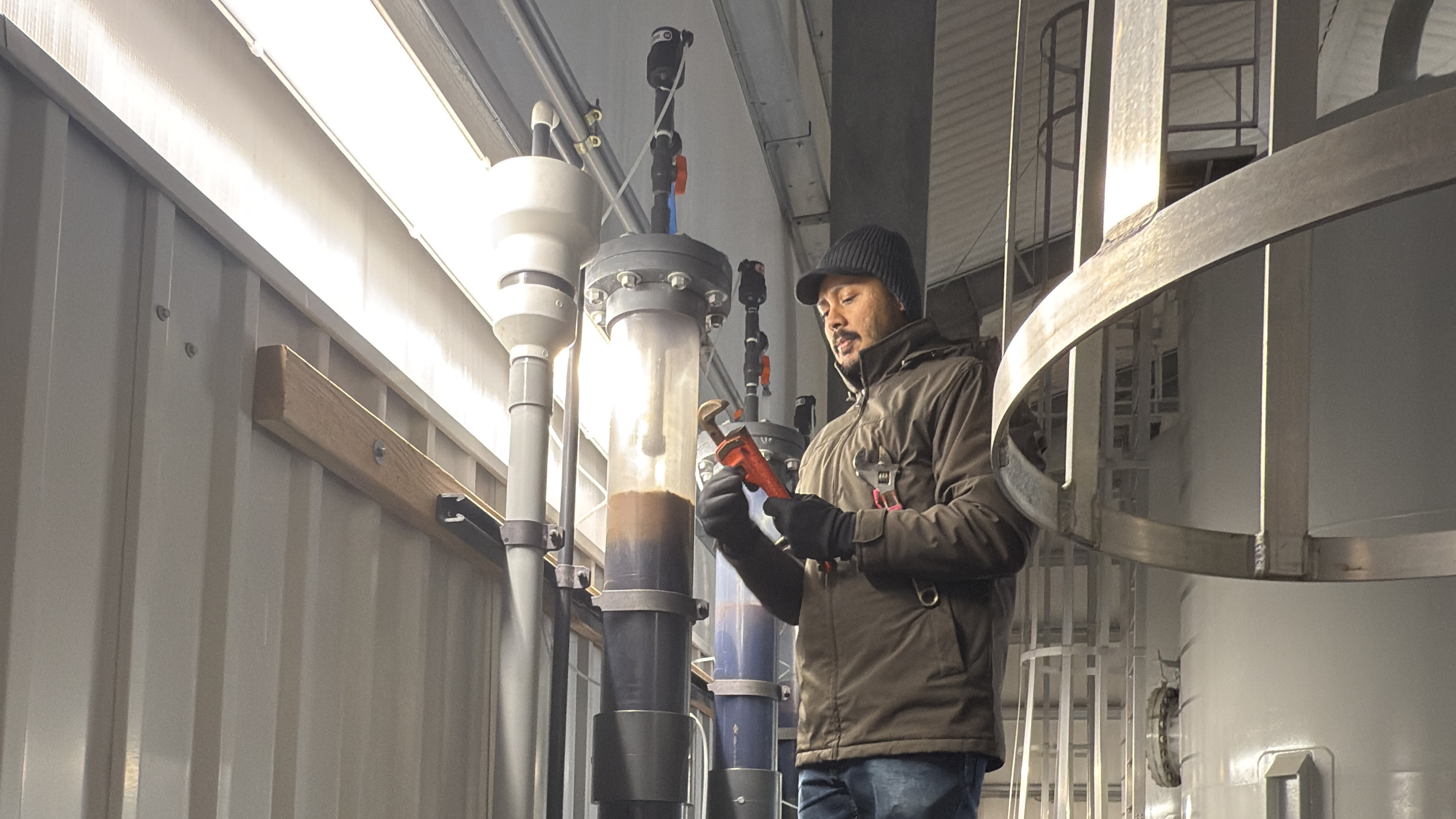 NJIT associate professor Arjun Venkatesan in the field, installing a modified granular activated carbon (GAC) pilot filtration column for testing PFAS treatment performance. Photo courtesy of Emerging Contaminants Research Laboratory at NJIT