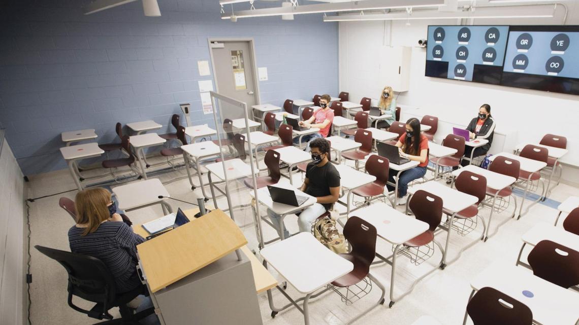 University Lecturer Catherine Siemann conducts her Honors Humanities class with students attending either in person or, via the back-wall screen, from a virtual location.