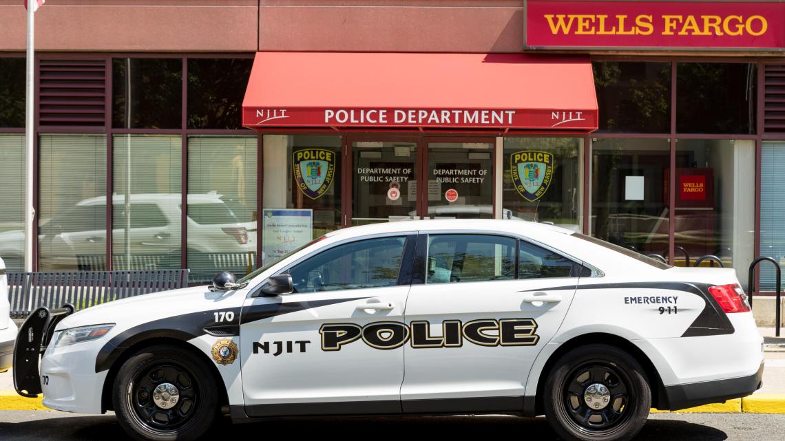 An NJIT Police car parked in front of the NJIT Police Department.