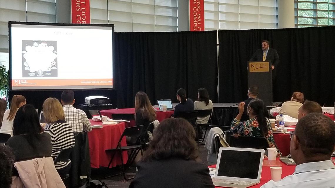 Forensic science professor, David Fisher, addresses the crowd at Pre-College's STEM Forum.