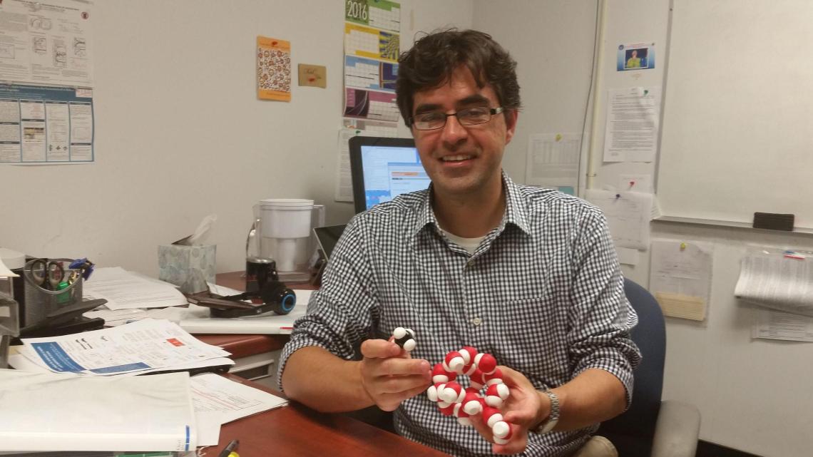 Assistant Professor Cristiano Dias explaining the molecular structure of a dangerous compound that can form in undersea natural gas pipelines. 