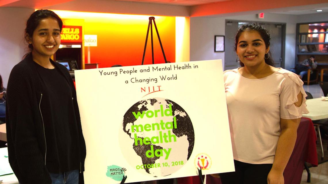 Mehak Farrukh, Minds Matter event planner (left), and Charu Arya, Minds Matter student president, publicize the new club and World Mental Health Day in the Campus Center.  