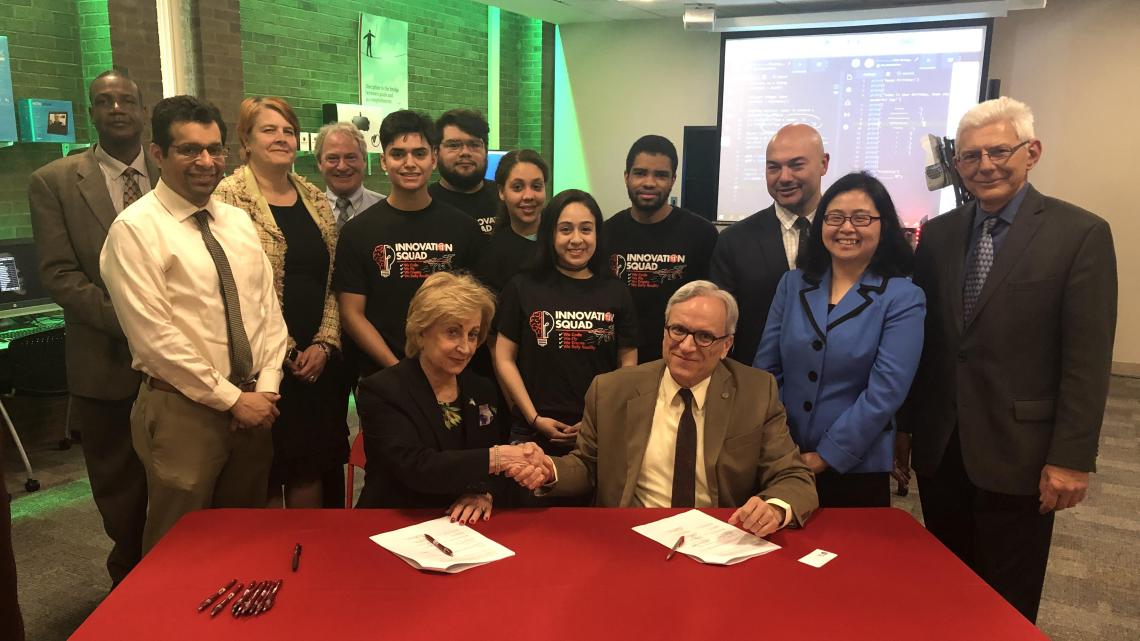Maris Lown (seated left), vice president of academic affairs, Union County College, and Fadi P. Deek, provost and senior executive vice president, NJIT, shake on it after signing a joint academic agreement between the two institutions. 