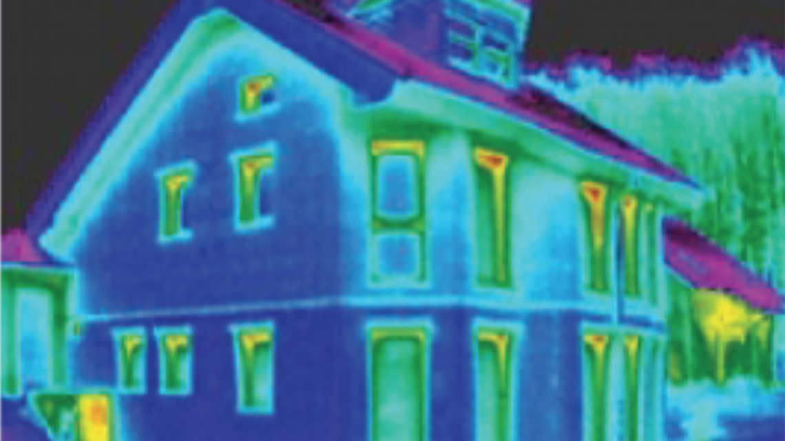 Infrared (IR) image of well insulated house showing minor leakage of heat near the tops of windows. 