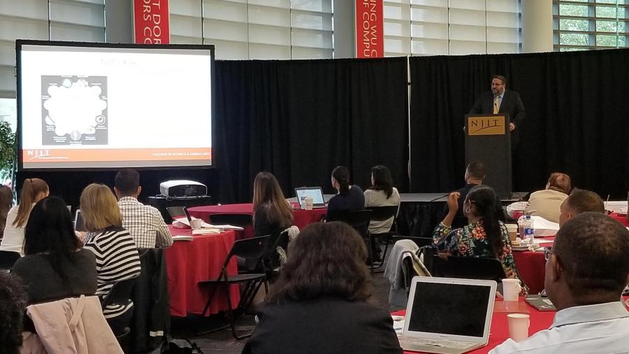 Forensic science professor, David Fisher, addresses the crowd at Pre-College's STEM Forum.