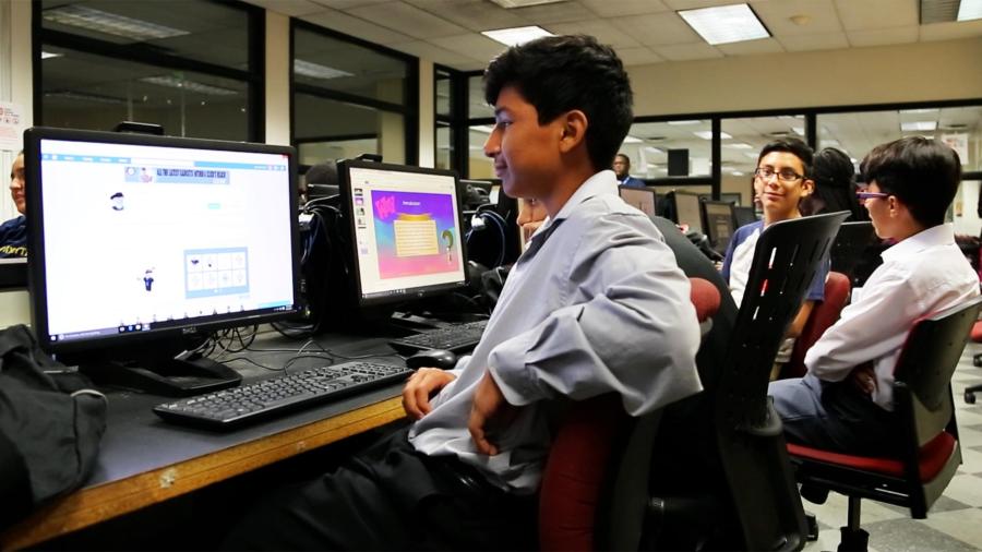 Pre-college students working on computers.