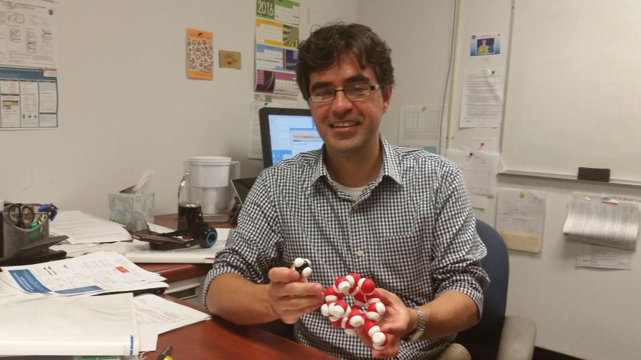 Assistant Professor Cristiano Dias explaining the molecular structure of a dangerous compound that can form in undersea natural gas pipelines. 