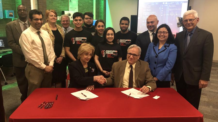 Maris Lown (seated left), vice president of academic affairs, Union County College, and Fadi P. Deek, provost and senior executive vice president, NJIT, shake on it after signing a joint academic agreement between the two institutions. 