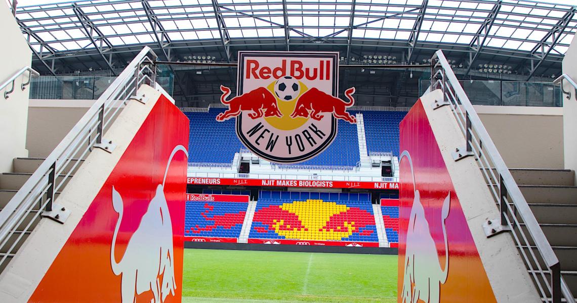 Red Bull Arena Entrance with "NJIT Makes Biologists" on the Ribbon LED Screen in Background