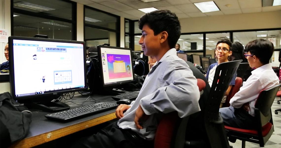 Pre-college students working on computers.