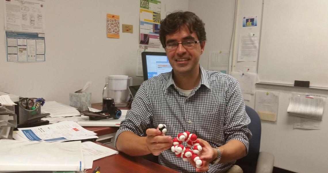 Assistant Professor Cristiano Dias explaining the molecular structure of a dangerous compound that can form in undersea natural gas pipelines. 