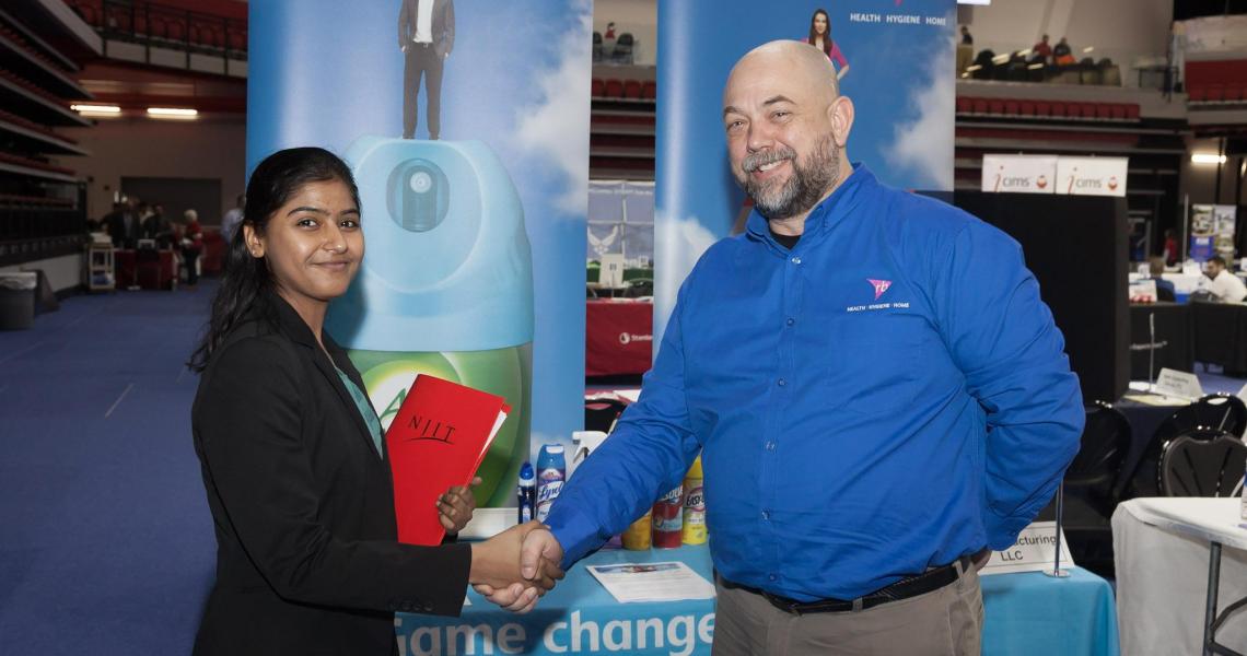 Student Eshita Shah meets with a recruiter at the Spring 2018 Career Fair.