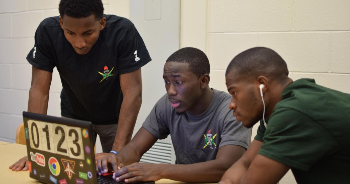 Norman Hamilton (center), internal vice president of the NJIT chapter of NSBE, collaborates with Angel Plaza (left), external vice president, NSBE, and Emmanuel Dortu, assistant secretary, African Student Association NJIT chapter, on designing the NSBE we
