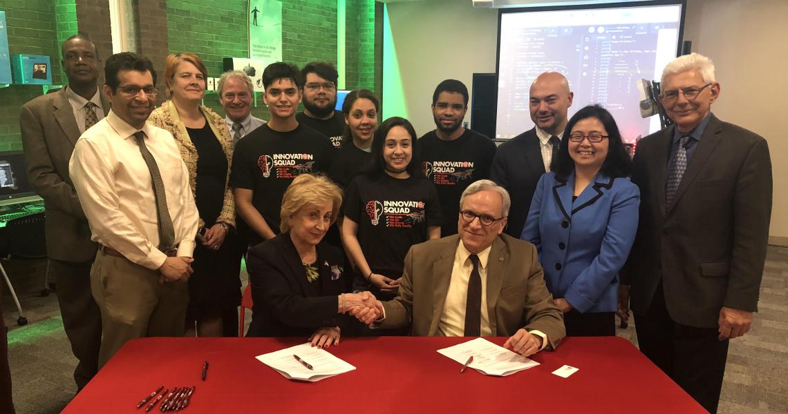 Maris Lown (seated left), vice president of academic affairs, Union County College, and Fadi P. Deek, provost and senior executive vice president, NJIT, shake on it after signing a joint academic agreement between the two institutions. 