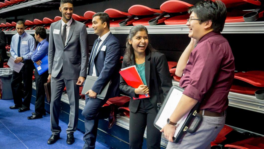 students smiling at a campus career fair 
