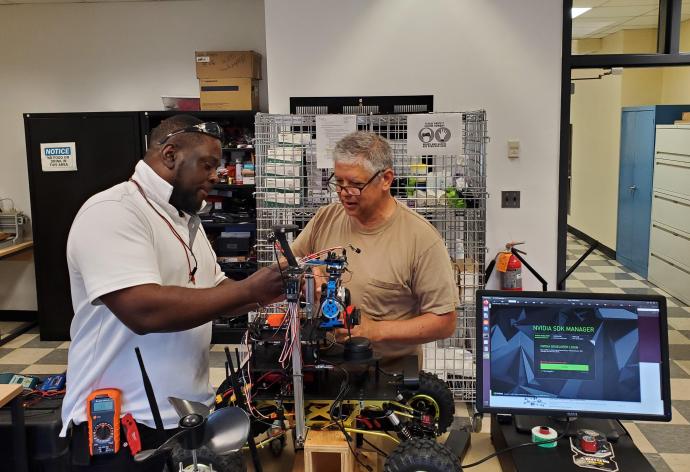 Amboise (left) and Potts (right) continue to develop the rover on NJIT's campus.
