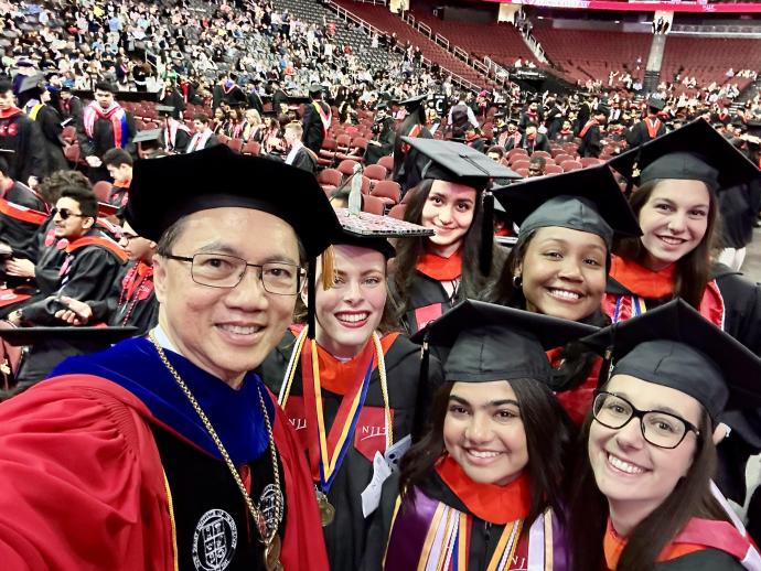 Members of the Class of 2023 and President Lim share a memory at commencement.