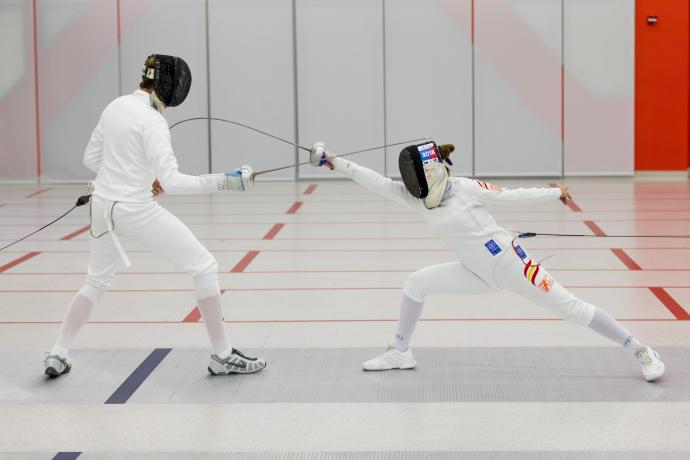 Through fencing, Marina (right) learns how to handle challenging situations.