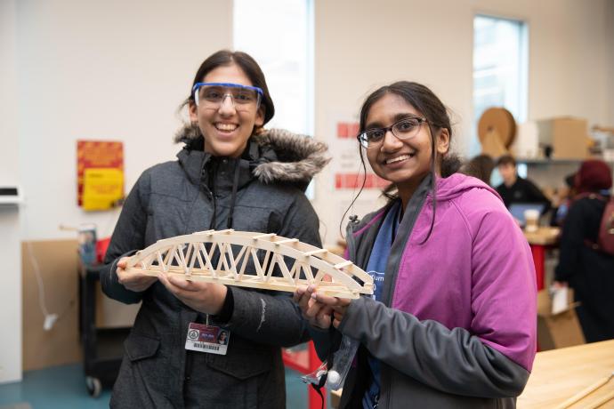 Riddhi Lamba (L) and Abigail Kumar (R) hold their well-built bridge that landed them great results during the competition. 