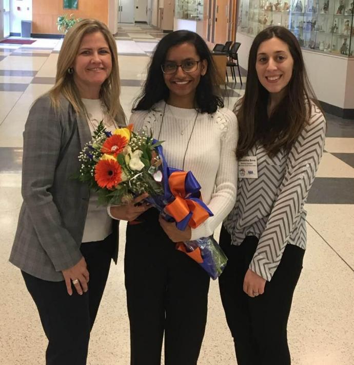 Saloni Patel (center), pre-dental Dorman Scholar and NJIT chair for Give Kids A Smile Day, received flowers as a thank you for her work with the program from the New Jersey Dental Association’s Maureen Barlow (left) and Samantha Bove. 