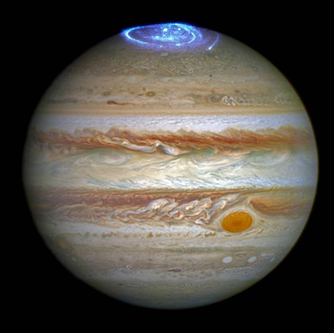 A 2016 composite image from NASA's Hubble Space Telescope used to study auroras — stunning light shows in a planet's atmosphere — on the poles of the largest planet in the solar system, Jupiter. (Credit: NASA)