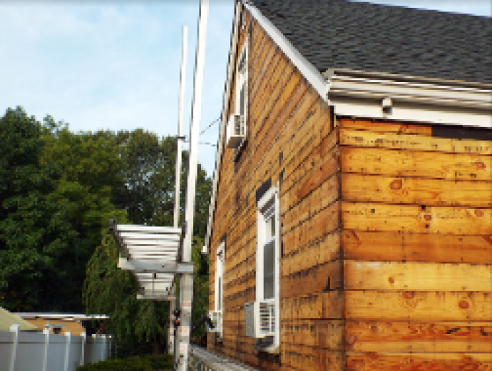 Old siding was removed exposing pine boards sheathing that leads to a high infiltration rate.