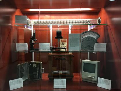 NJIT Distributed Technology Museum’s first 7-piece exhibit displayed in Fenster Hall (Top Shelf: York-Scheibel Column; Middle Shelf, Left: 1947 Bausch & Lomb optical microscope; Middle Shelf, Center: Brookefield Viscometer; Middle Shelf, Right: Weston Sta