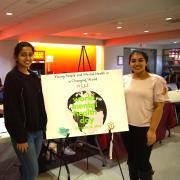 Mehak Farrukh, Minds Matter event planner (left), and Charu Arya, Minds Matter student president, publicize the new club and World Mental Health Day in the Campus Center.  